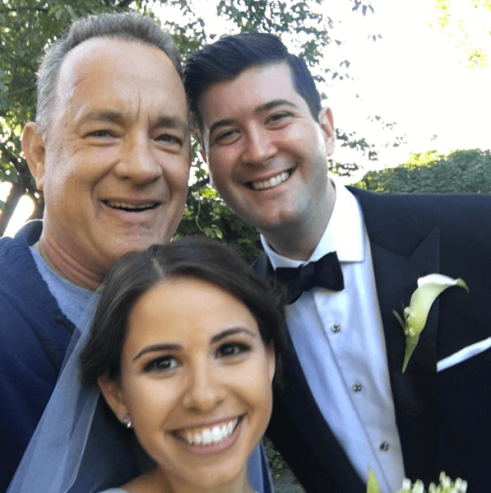 Hollywood star Tom Hanks poses with a couple on their wedding day in Central Park September, 2016.