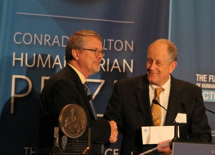 President and CEO of The Task Force for Global Health, David Ross (R) accepts the Conrad N. Hilton Humanitarian Prize from Hilton Foundation president and CEO Peter Laugharn (L) at the Waldorf Astoria New York on Friday September 30, 2016.