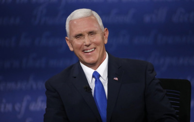 Republican U.S. vice presidential nominee Governor Mike Pence laughs as he discusses an issue with Democratic U.S. vice presidential nominee Senator Tim Kaine (off camera) during their vice presidential debate at Longwood University in Farmville, Virginia, U.S., October 4, 2016.