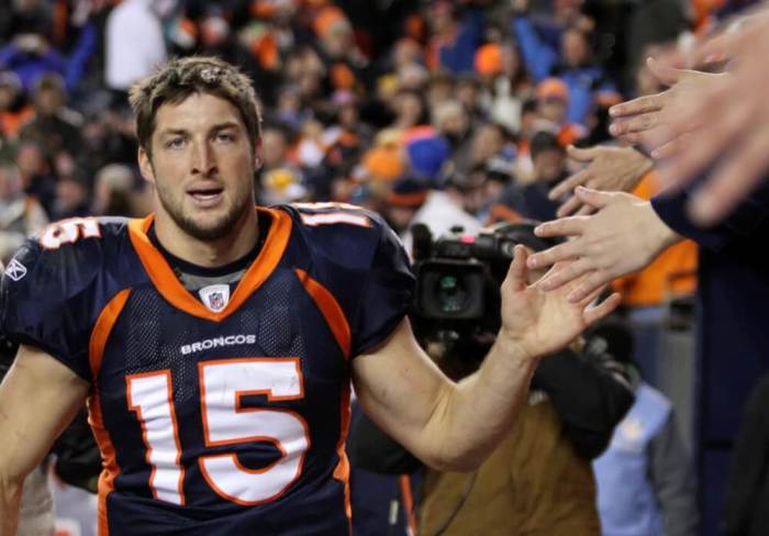 Denver Broncos quarterback Tim Tebow celebrates with fans after the Broncos defeated the Pittsburgh Steelers in overtime in the NFL AFC wildcard playoff football game in Denver, Colorado, January 8, 2012.