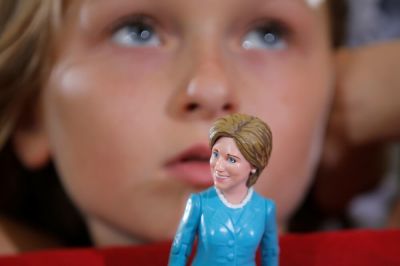 Nine-year-old Belle Shefrin holds a doll of U.S. Democratic presidential nominee Hillary Clinton while listening to Clinton speak at a campaign rally in Akron, Ohio, U.S., October 3, 2016.