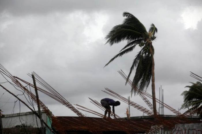 A man fixes a roof of a partially built house after Hurricane Matthew in Les Cayes, Haiti, October 5, 2016.