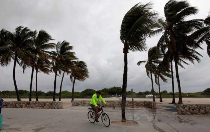 A man rides his bicycle along the beach prior to the arrival of Hurricane Matthew in Miami Beach, Florida, U.S. October 6, 2016.