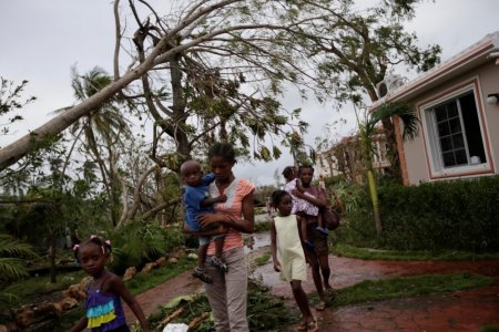 People leave Hotel Villa Mimosa where about 200 people were sheltered during Hurricane Matthew in Les Cayes, Haiti, October 6, 2016.