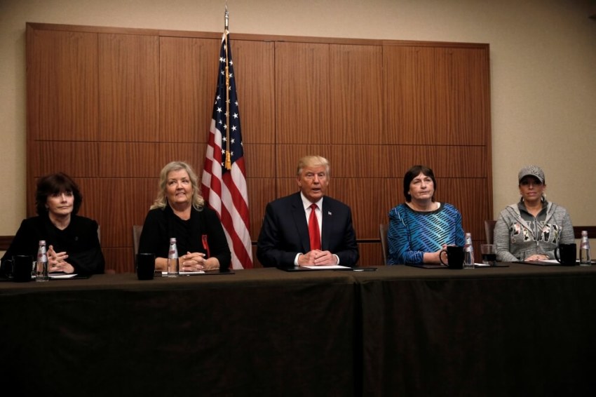Republican presidential nominee Donald Trump sits with (from R-L) Paula Jones, Kathy Shelton, Juanita Broaddrick, Kathleen Willey in a hotel conference room in St. Louis, Missouri, U.S., shortly before the second presidential debate at Washington University in St. Louis, October 9, 2016.