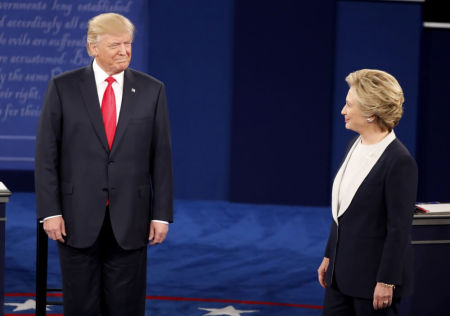 Donald Trump and Hillary Clinton acknowledge each other at the start of their presidential town hall debate in St. Louis, Missouri, October 10, 2016.