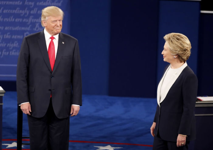 Donald Trump and Hillary Clinton acknowledge each other at the start of their presidential town hall debate in St. Louis, Missouri, October 10, 2016.