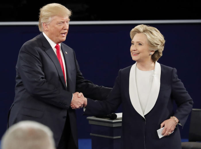 Republican U.S. presidential nominee Donald Trump and Democratic U.S. presidential nominee Hillary Clinton shake hands at the end of their presidential town hall debate at Washington University in St. Louis, Missouri, U.S., October 9, 2016.