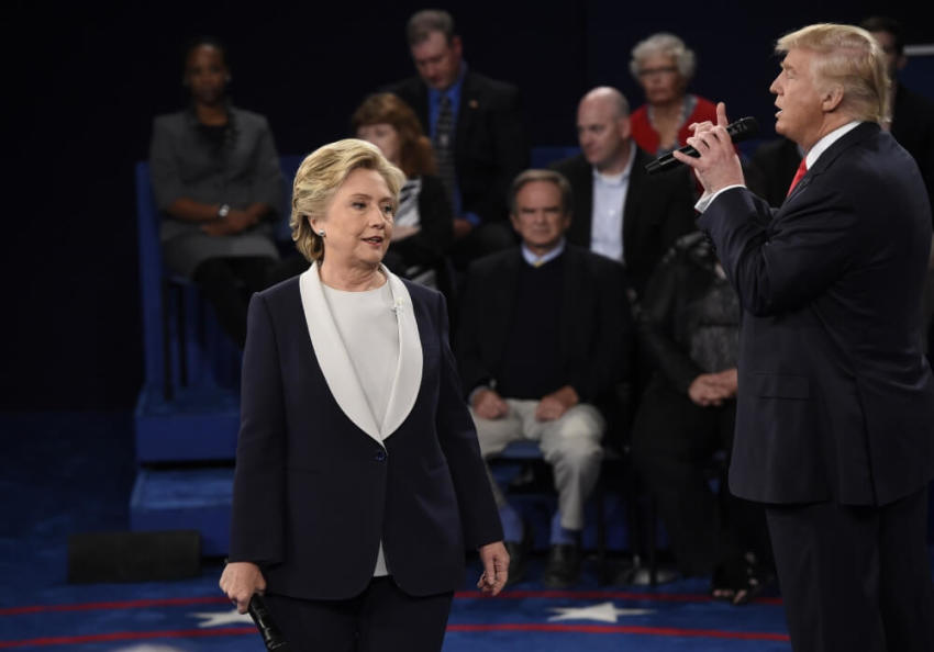 Democratic nominee Hillary Clinton reacts as Republican U.S. presidential nominee Donald Trump (R) answers a question during their presidential town hall debate at Washington University in St. Louis, Missouri, U.S., October 9, 2016.