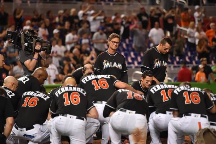 Marlins manager Don Mattingly watches as his team takes a knee around the pitchers mound to honor Jose Fernandez after defeating the New York Mets 7-3 at Marlins Park.