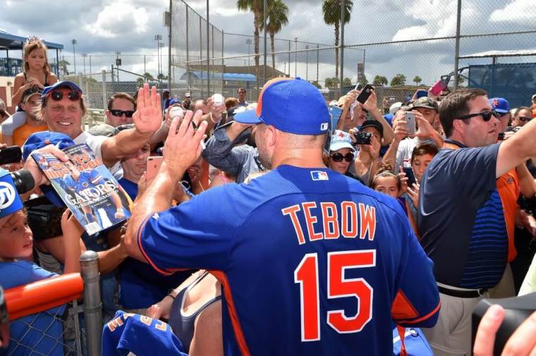 New York Mets outfielder Tim Tebow (15) high fives a fan after his workout at the Mets Minor League Complex, Port St. Lucie, Florida, September 19, 2016.