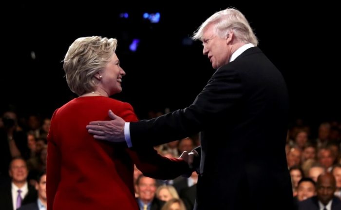 Donald Trump shakes hands with Hillary Clinton.