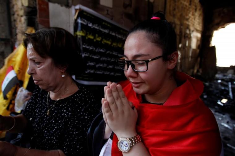 A Christian prays for the victims during Eid al-Fitr, the end of the fasting month of Ramadan, at the site of a suicide car bomb attack over the weekend at the shopping area of Karrada, in Baghdad, Iraq July 8, 2016.