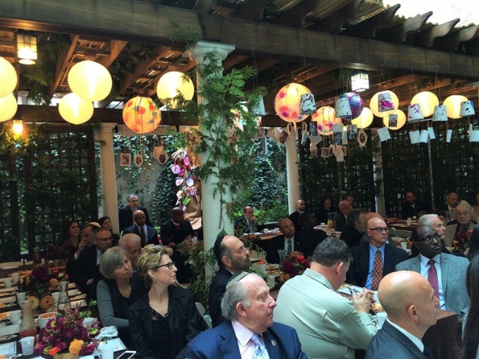 Attendees have breakfast inside a Sukkah at the Sukkah in the Sky event held at the Edmond J. Safra Synagogue in New York City on Thursday October 20, 2016.