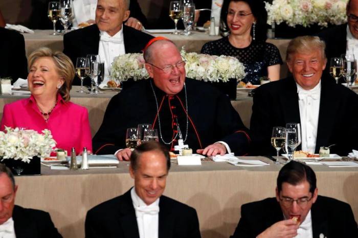 Democratic presidential nominee Hillary Clinton, Archbishop of New York Cardinal Timothy Dolan and Republican presidential nominee Donald Trump sit together at the Alfred E. Smith Memorial Foundation dinner in New York, October 20, 2016.