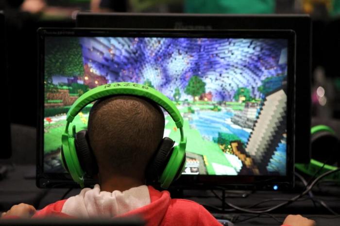 A child plays video game Minecraft at the Minecon convention in London July 4, 2015. The 10,000 tickets sold for Minecon in London made it the largest ever convention for a single video game.