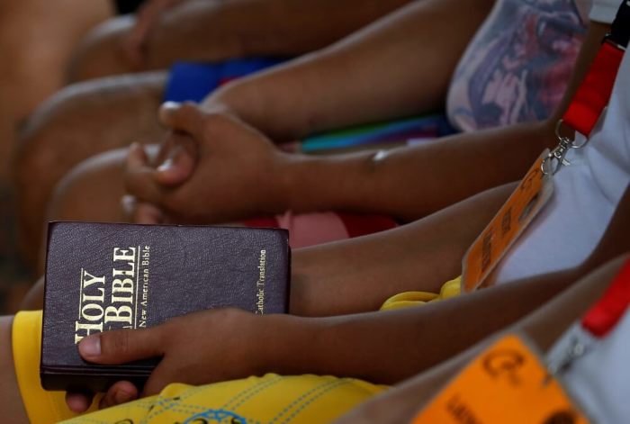 A drug user holds a Bible before the start of a Yoga session at Center for Christian Recovery, a private drug rehabilitation center, in Antipolo, Rizal, in the Philippines, September 28, 2016.