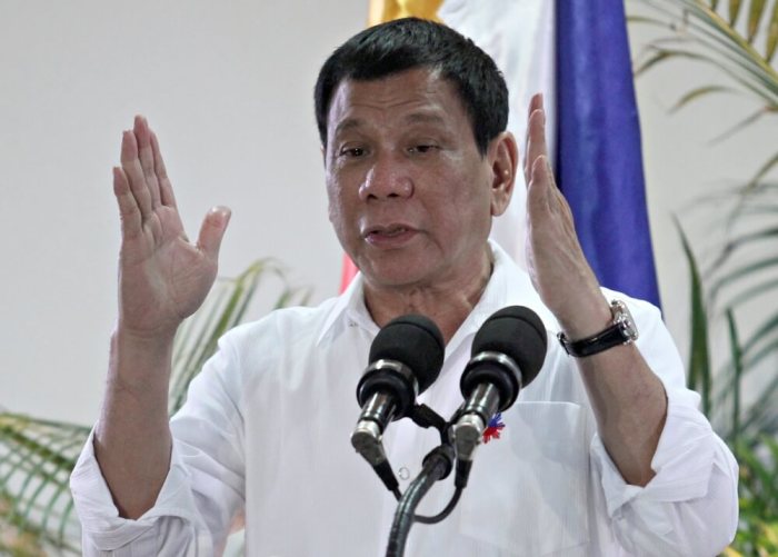 Philippine President Rodrigo Duterte gestures while answering questions during a news conference upon his arrival from a state visit in Japan at the Davao International Airport in Davao city, Philippines, October 27, 2016.