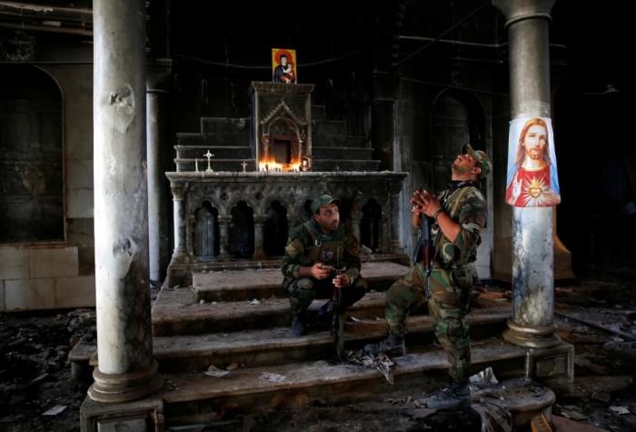 Iraqi Christian soldiers attend the first Sunday mass at the Grand Immaculate Church since it was recaptured from Islamic State in Qaraqosh, near Mosul in Iraq October 30, 2016.