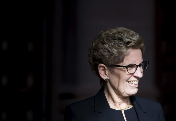 Ontario Premier Kathleen Wynne smiles as she awaits Canada's Prime Minister designate Justin Trudeau to arrive Queen's Park in Toronto, October 27, 2015.