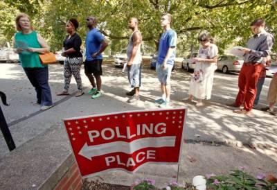 People arrive to cast their ballot for 2016 elections at a polling station as early voting begins in North Carolina, in Carrboro, North Carolina, U.S., October 20, 2016.