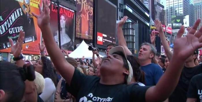 Fans sing along with Matt Redman as he performs his hit song '10,000 Reasons' in New York City's Times Square on August 1, 2016.
