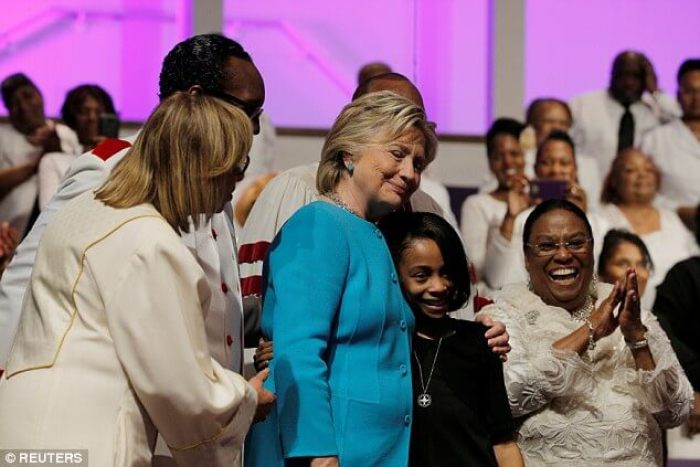 Hillary Clinton got a hug from 11-year old Gabrielle Green, who delivered a rousing rendition of 'America the Beautiful' backed by the church choir at Mt. Airy Baptist Church in Philadelphia on November 6, 2016.