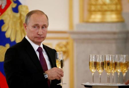 Russia's President Vladimir Putin holds a glass during a ceremony of receiving diplomatic credentials from foreign ambassadors at the Kremlin in Moscow, Russia, November 9, 2016.
