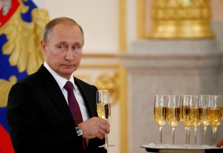 Russia's President Vladimir Putin holds a glass during a ceremony of receiving diplomatic credentials from foreign ambassadors at the Kremlin in Moscow, Russia, November 9, 2016.