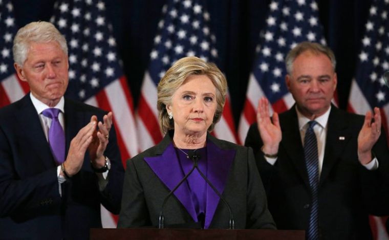 Hillary Clinton, accompanied by her husband former U.S. President Bill Clinton (L) and running mate Senator Tim Kaine, addresses her staff and supporters about the results of the U.S. election at a hotel in New York, November 9, 2016.