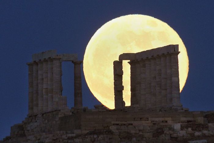 A supermoon rises over the temple of Poseidon, the ancient Greek god of the seas, in Cape Sounion some 60 km (37 miles) east of Athens June 23, 2013. On Sunday a perigee moon coincides with a full moon creating a 'super moon' when it will pass by the earth at its closest point in 2013.