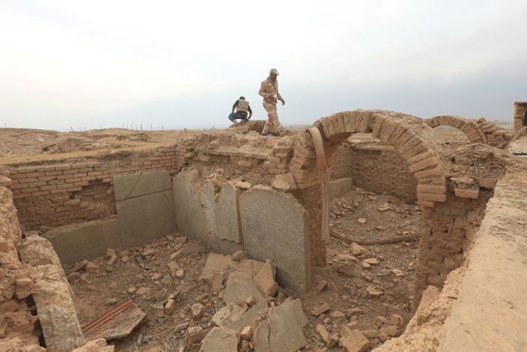 A member of Iraqi army walks at the remains of wall panels and colossal statues of winged bulls, destroyed by Islamic State militants in the Assyrian city of Nimrud eastern bank of the Tigris River, south of Mosul, Iraq, November 16, 2016.