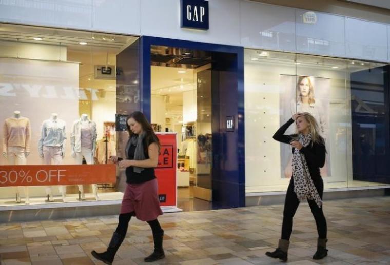 Passers-by walk next to a Gap store in Broomfield, Colorado February 27, 2014.