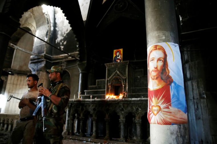 Iraqi Christian soldiers attend the first Sunday mass at the Grand Immaculate Church since it was recaptured from Islamic State in Qaraqosh, near Mosul in Iraq, October 30, 2016.
