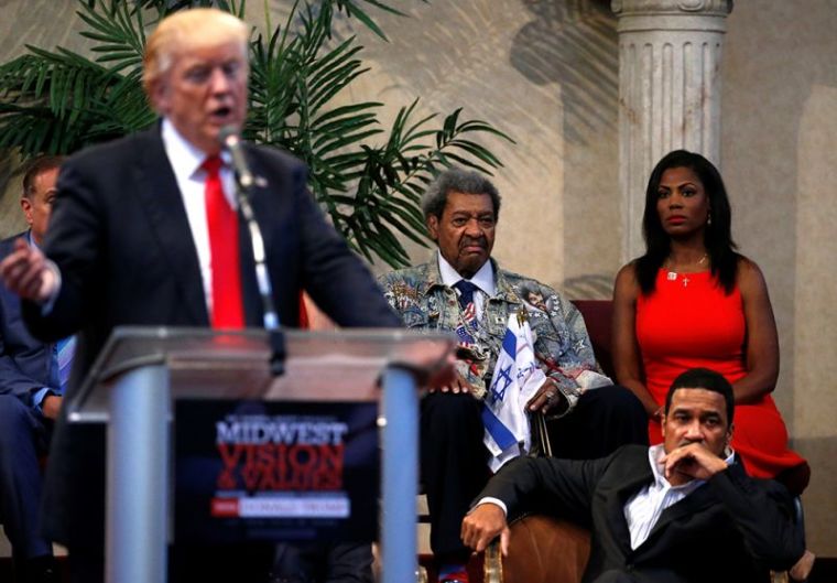 Promoter Don King, Omarosa Manigault and Pastor Darrell Scott listen to remarks by Republican presidential nominee Donald Trump at the New Spirit Revival Center in Cleveland Heights, Ohio, September 21, 2016.