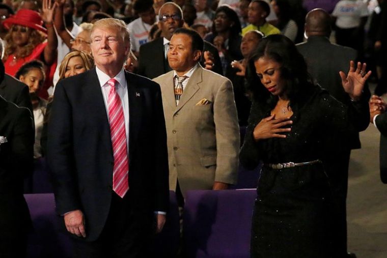Republican presidential nominee Donald Trump and Omarosa Manigault (R) attend a church service, in Detroit, Michigan, September 3, 2016.