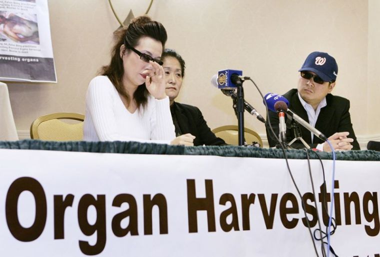 Protester Wang Wenyi (C) sits with unidentified Chinese citizens during a news conference about why she screamed out last week at a White House arrival ceremony hosted by U.S. President George W. Bush for Chinese President Hu Jintao on the South Lawn, in Arlington, Virginia, April 26, 2006. Wang called out to Hu and Bush during the ceremony to stop what she said was organ harvesting from live Falun Gong practitioners in China's labor camps.