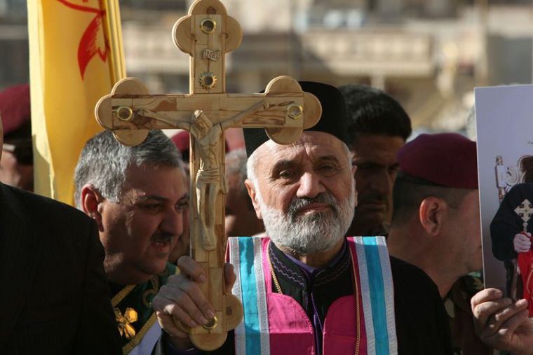 Iraqi Christians take part in a procession to erect a new cross over the Mar Korkeis church, after the original cross was destroyed by Islamic State militants, in the town of Bashiqa, Iraq, November 19, 2016.