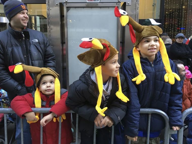 Spectators wait on 6th Ave prior to start of the 89th Macy's Thanksgiving Day Parade in the Manhattan borough of New York, November 26, 2015.