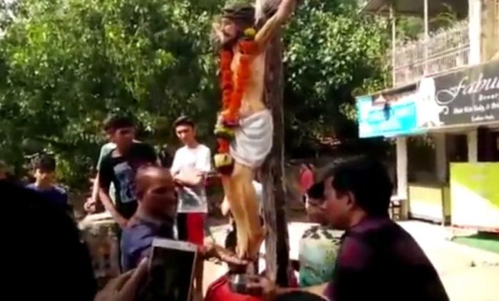 People collecting 'holy water' from the feet of a Jesus Christ statue in Kharodi, a predominantly Catholic village near Mumbai in India, in a video released in November 2016.