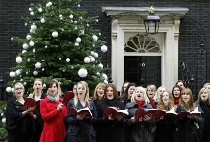 A choir sings Christmas carols outside number 10 Downing Street before a reception with Britain's Prime Minister David Cameron in London on December 6, 2011.