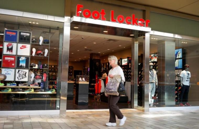 A woman walks by the Foot Locker store in Broomfield, Colorado March 4, 2015.
