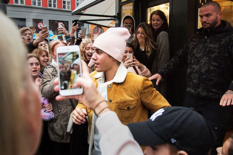 Singer Justin Bieber leaves the store STORM as he is surrounded by fans, in Copenhagen, Denmark October 2, 2016. The store has been selling official merchandise for Bieber's 'Purpose' tour, which will be playing on Sunday night at Telia Parken.
