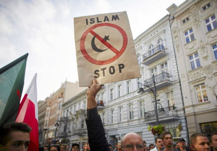 A protester from a far-right organization holds up a sign which reads 'Islam Stop' during a protest against refugees in Lodz, Poland, in this undated photo.