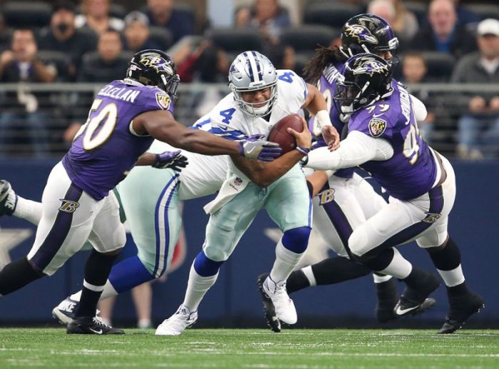 Dallas Cowboys quarterback Dak Prescott (4) is sacked in the first quarter by Baltimore Ravens linebacker Zachary Orr (50) and defensive tackle Timmy Jernigan (99) at AT&T Stadium, Arlington, Texas, November 20, 2016.