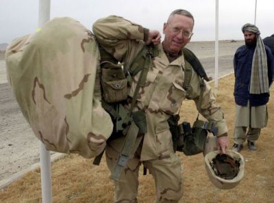 Brig. Gen. James Mattis carries his packs into the Kandahar International Airport, where he will set up operations after arriving here December 14, 2001. The U.S. Marines have taken control of the airfield and have the mission of making it ready to receive fixed wing aircraft.