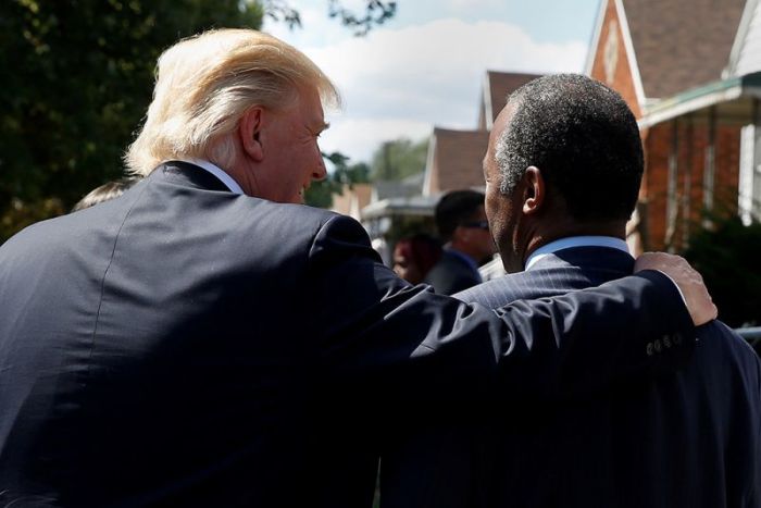 Republican presidential then nominee Donald Trump and Ben Carson walk to Carson's childhood home in Detroit, Michigan, U.S. September 3, 2016.