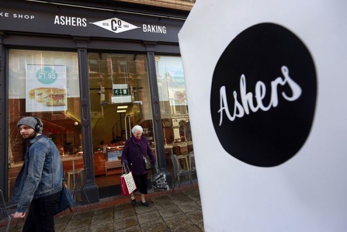 A woman leaves Ashers bakery in Belfast, March 26, 2015. 