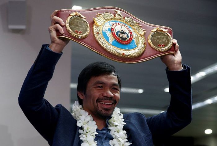 Filipino boxer and Senator Manny Pacquiao raises his boxing winning belt during a news conference upon arrival, after winning WBO welterweight bout with Jessie Vargas, at Ninoy Aquino International airport in Paranaque, Metro Manila in the Philippines, November 8, 2016.