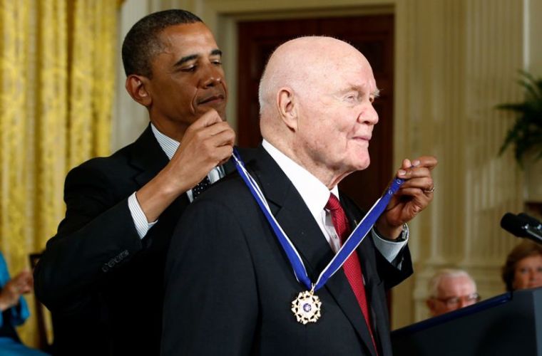 U.S. President Barack Obama awards a 2012 Presidential Medal of Freedom to astronaut and former U.S. Senator John Glenn during a ceremony in the East Room of the White House in Washington, May 29, 2012.